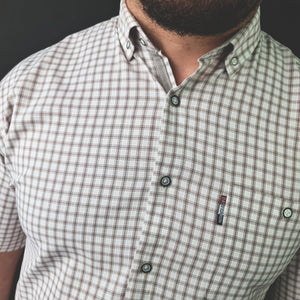 a man with a beard wearing a checkered shirt