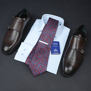 a tie, dress shirt, and dress shoes are laid out