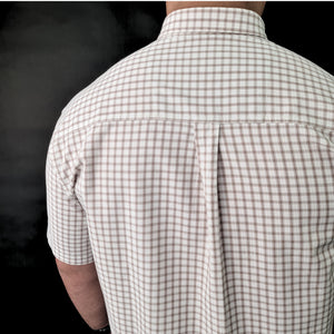 a man wearing a white and brown checkered shirt