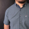 a man with a beard wearing a checkered shirt