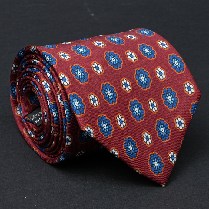 a red tie with blue flowers on it