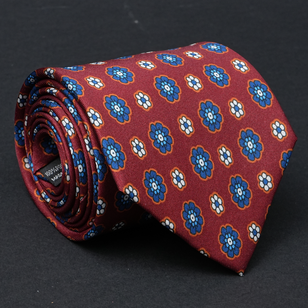 a red tie with blue flowers on it