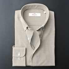 a dress shirt with a tie on a black background