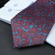a red and blue tie sitting on top of a black table
