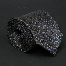 a close up of a tie on a black surface