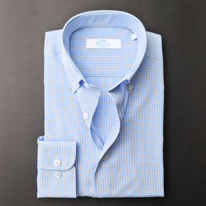 a blue and white checkered shirt on a black surface