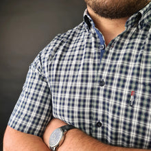a man with his arms crossed wearing a watch