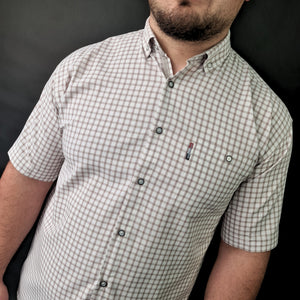a man with a beard wearing a checkered shirt