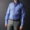 a man wearing a blue shirt and gray pants