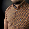 a man with a beard wearing a checkered shirt