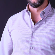 a man with a beard wearing a purple shirt