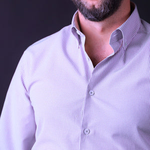a man with a beard wearing a purple shirt