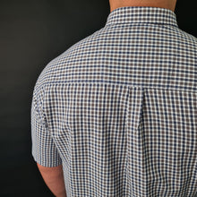 a man wearing a blue and white checkered shirt
