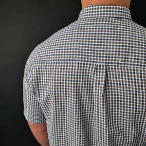 a man wearing a blue and white checkered shirt