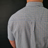 a man wearing a blue and white checkered shirt