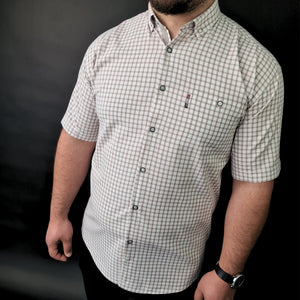 a man with a beard wearing a shirt and black pants