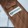 a close up of a tie with a name tag on it