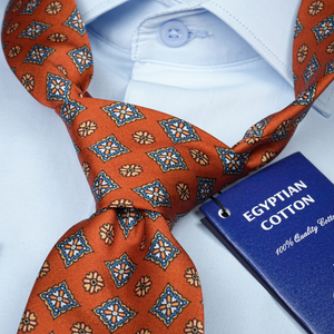a close up of a tie with a book on it