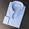 a blue shirt with a white checkered pattern