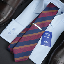a striped tie with a white shirt and brown shoes