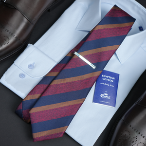 a striped tie with a white shirt and brown shoes