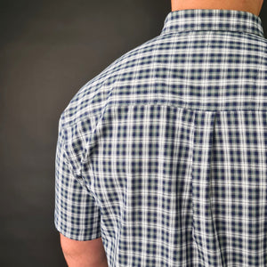 a man wearing a blue and white checkered shirt