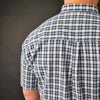 a man wearing a blue and white checkered shirt