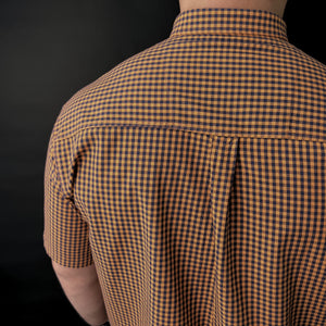 the back of a man's shirt with a checkered pattern