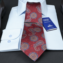 a red tie with a white shirt and a blue book