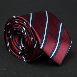 a close up of a tie on a black surface