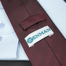 a close up of a tie with a name tag on it