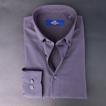 a purple shirt with a blue label on it