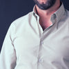 a man with a beard wearing a white shirt