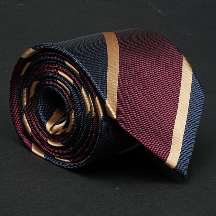 a close up of a tie on a black surface