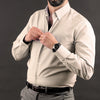a man adjusting his tie while wearing a dress shirt