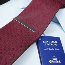 a close up of a red tie and a blue passport