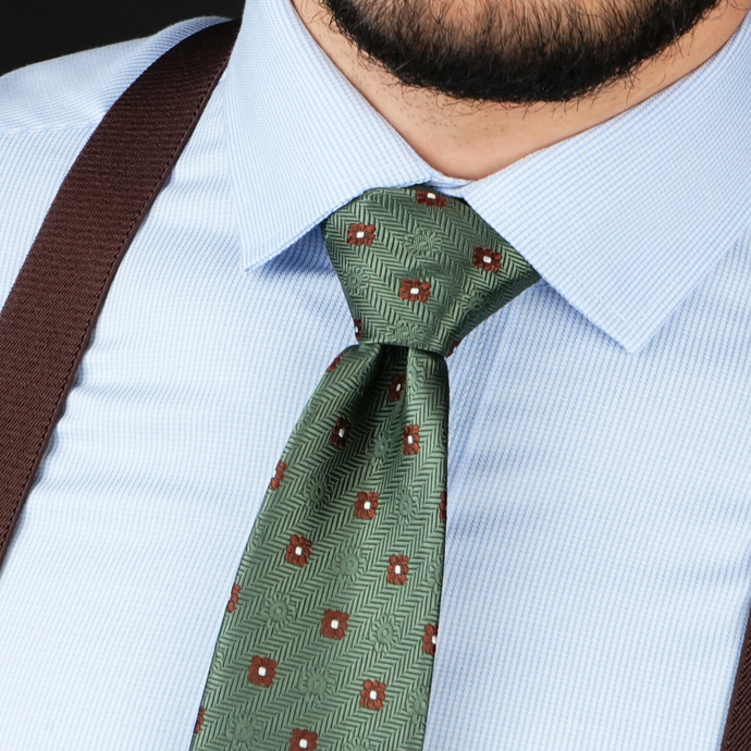 a close up of a man wearing a tie and suspenders