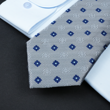 a close up of a tie and a dress shirt
