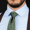 a close up of a man wearing a tie and suspenders