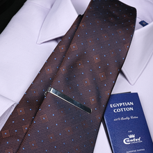 a tie and a passport on a white shirt