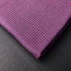 a close up of a pink and blue checkered tie