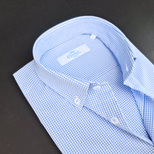a blue and white checkered shirt on a black surface