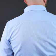 a man with a bald head wearing a blue shirt