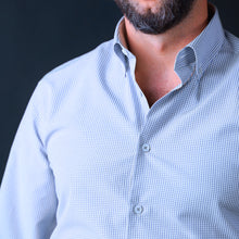 a man with a beard wearing a blue shirt