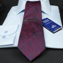 a purple tie with a white shirt and a blue card