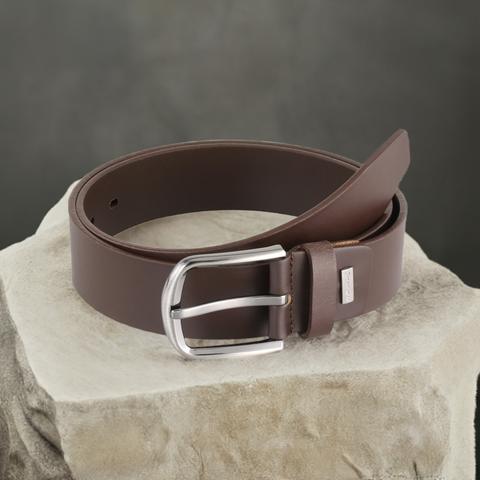 a brown belt sitting on top of a rock