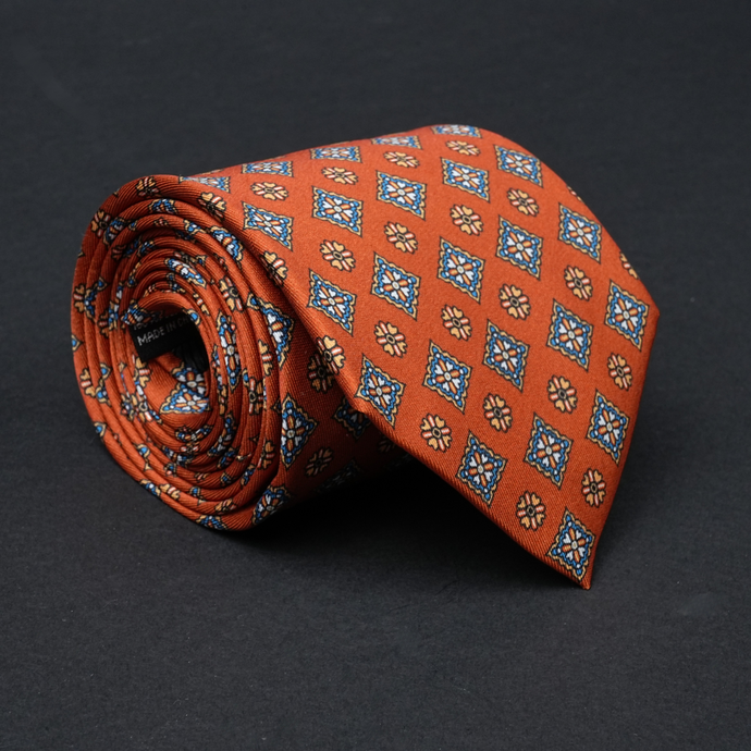 a close up of a tie on a black surface