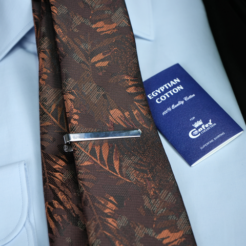 a close up of a tie with a badge on it