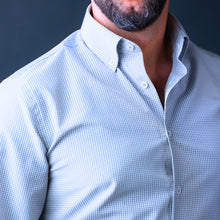 a man with a beard wearing a blue shirt
