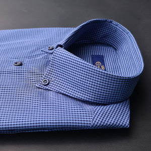 a blue and white checkered shirt sitting on top of a table